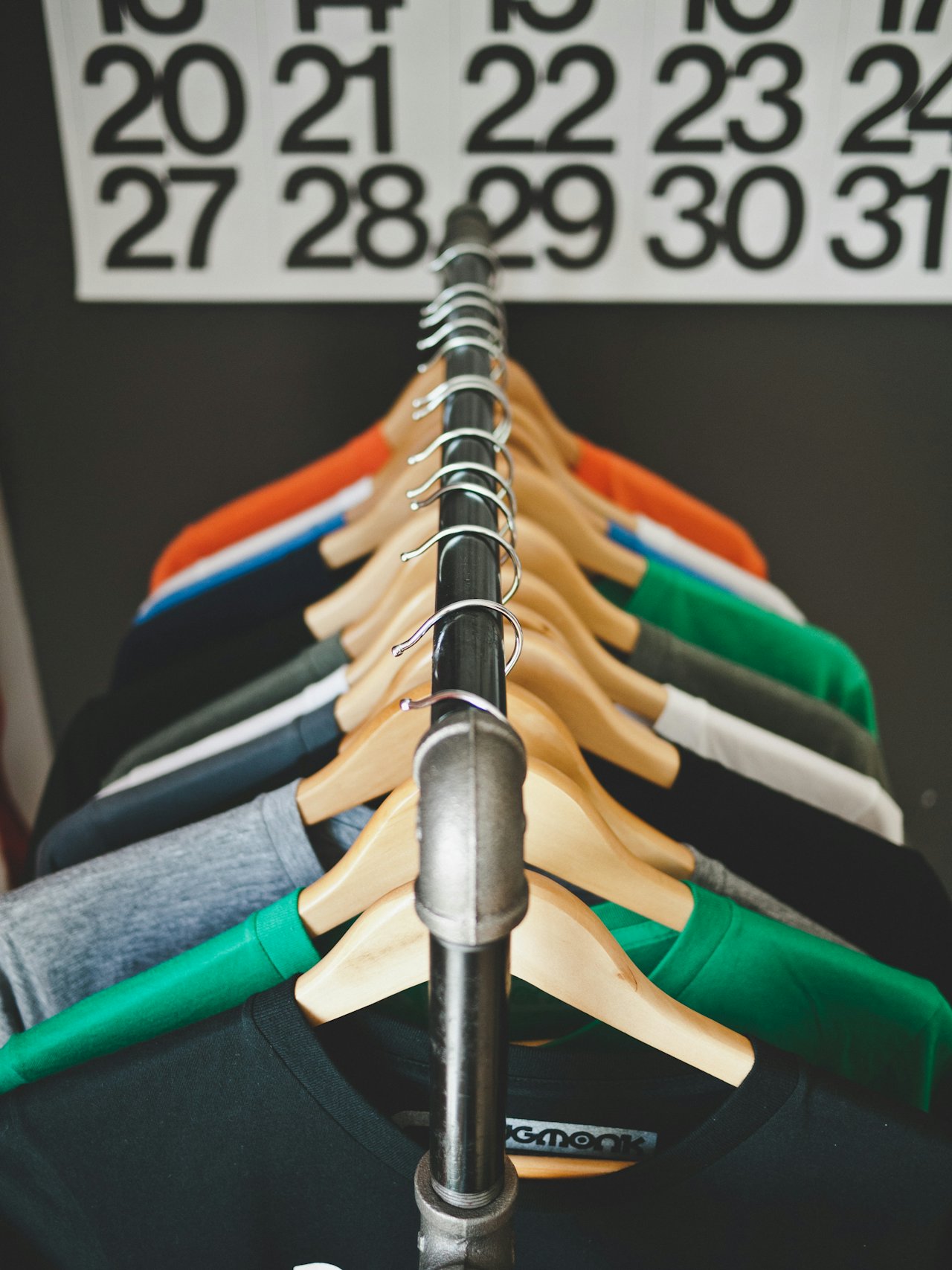 T-shirts in many colours on hangers