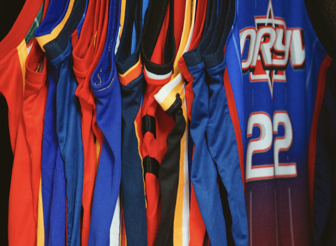Rack of colourful sports jerseys with numbers